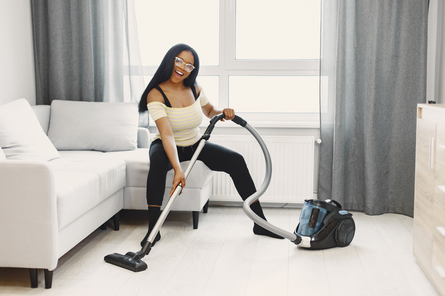 Woman with Vacuum in Living Room